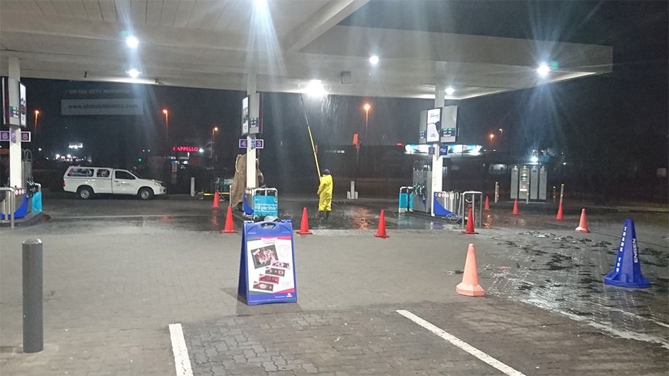 Petrol station cleaning at night in Johannesburg