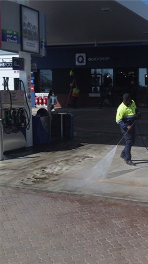 Focused lance washdown on petrol station paving